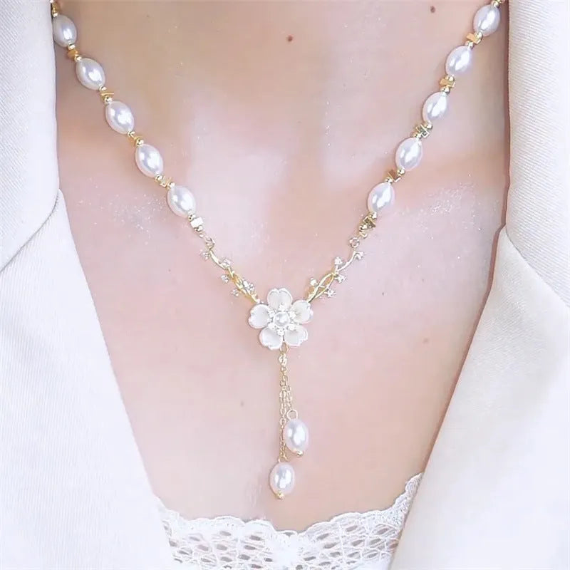 Women's alloy necklace with pearl flower design and rose accents on pearl chain