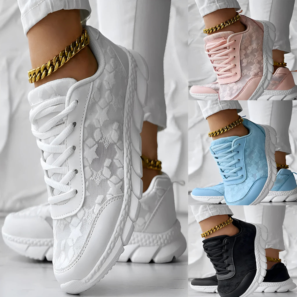 Women's casual canvas sports shoe in four colour options: white, black, blue, and pink, shown with a flat heel.