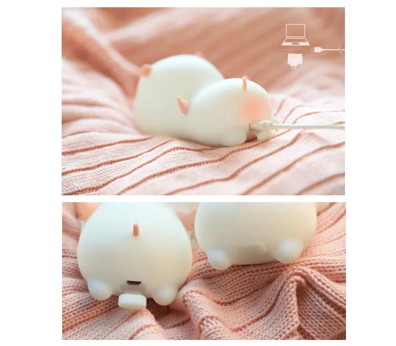 Pink silicone pig-shaped night light with touch control on bedside table