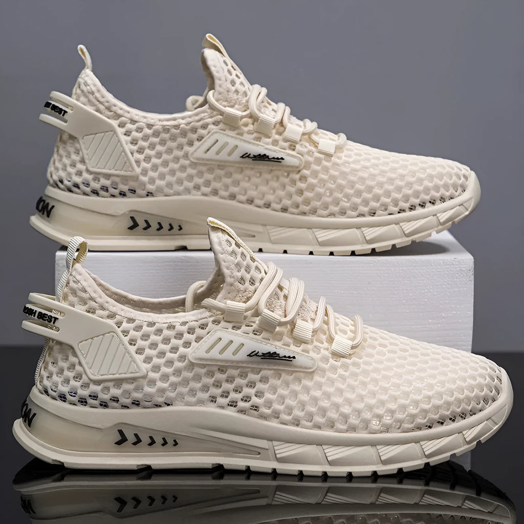Men's beige casual sneakers with synthetic leather upper and mesh detailing, showing lace-up front and low-profile EVA sole.