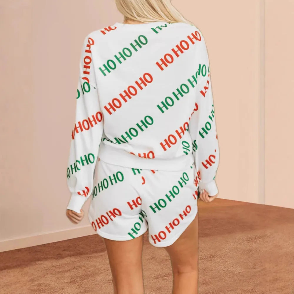 White women's two-piece suit with black letters printed design, featuring long sleeves and coordinated trousers