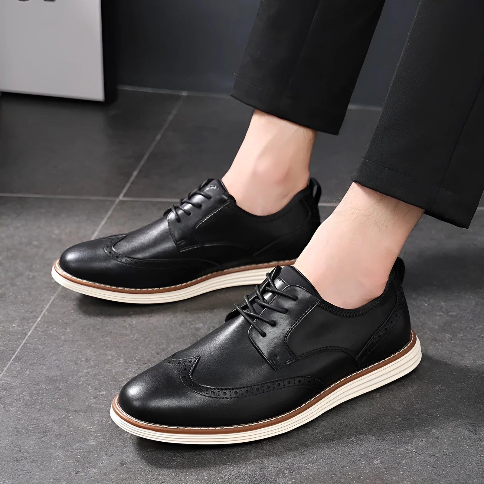 Men's black and brown slip-on business casual shoes with round toe and carved pattern detail
