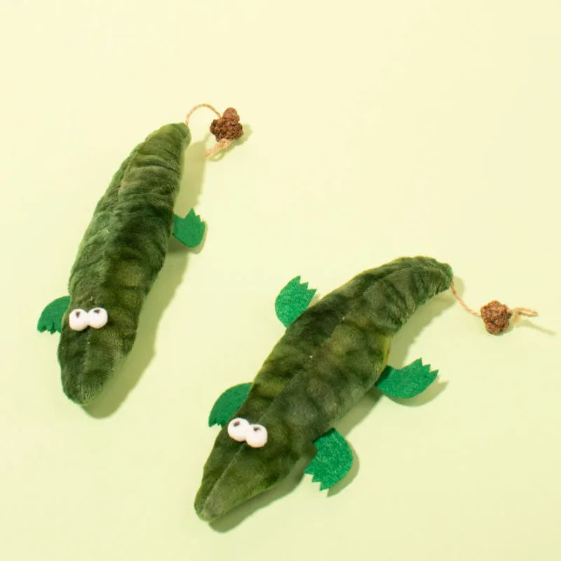 Green plush alligator cat toy with catnip and peppermint scent for oral cleansing and play.