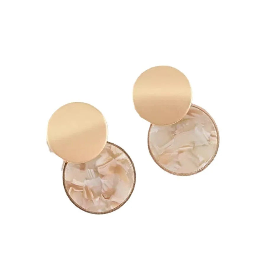 Retro personalized round matte resin female earrings with rotundity shape on a neutral background