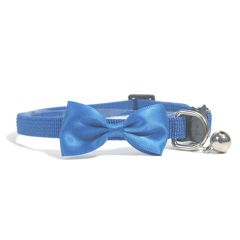 Adjustable nylon cat collar with decorative bow and bell in striped cartoon pattern, multiple colour options shown