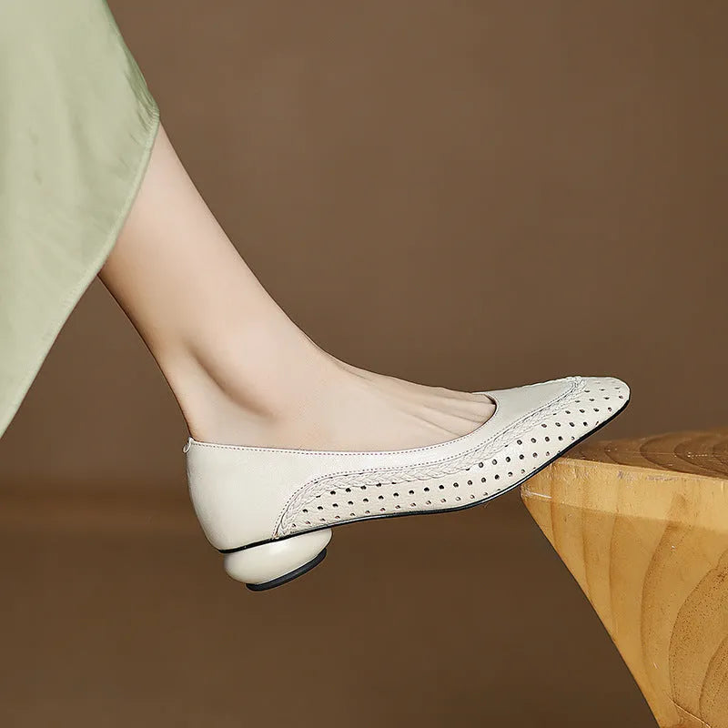 Women's beige sheepskin sandals with hollow-out design, round toe, and mid heel.