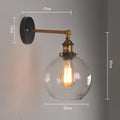 Round glass wall lamp with aluminium holder in transparent, amber, or smoky grey colour options