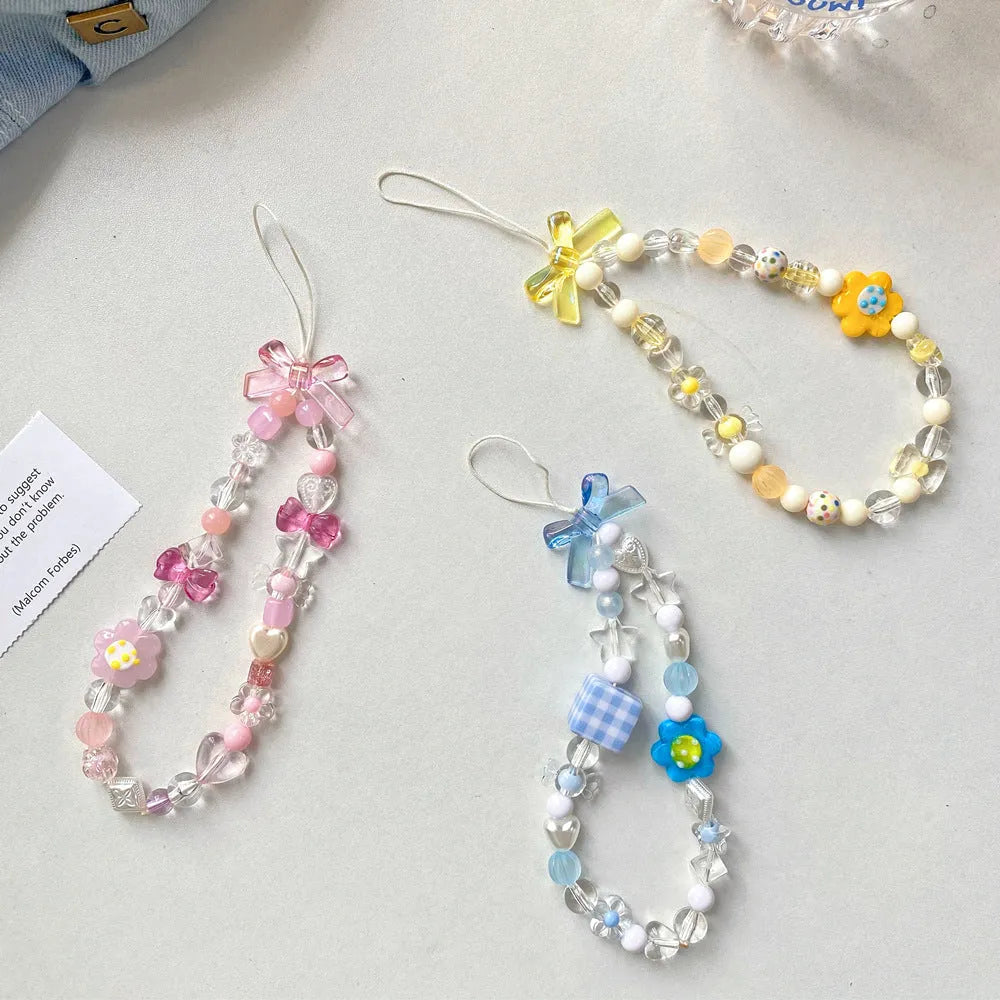 Beaded flower mobile phone lanyard with adjustable sliding bead in blue, pink, and yellow colour options