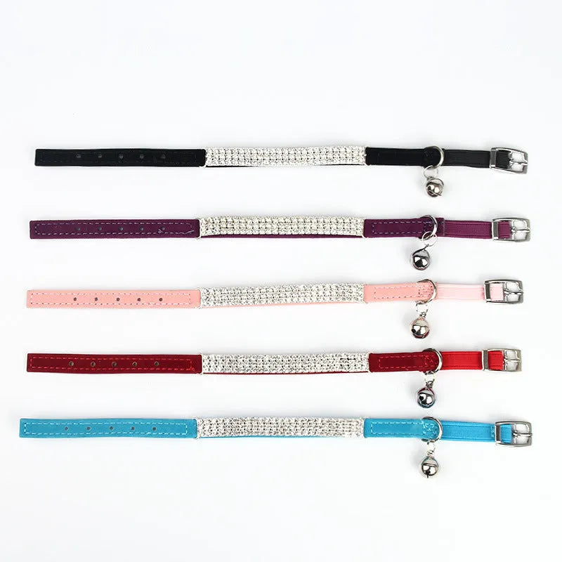 Red velvet cat collar with rhinestones, adjustable buckle, shown on a white background.