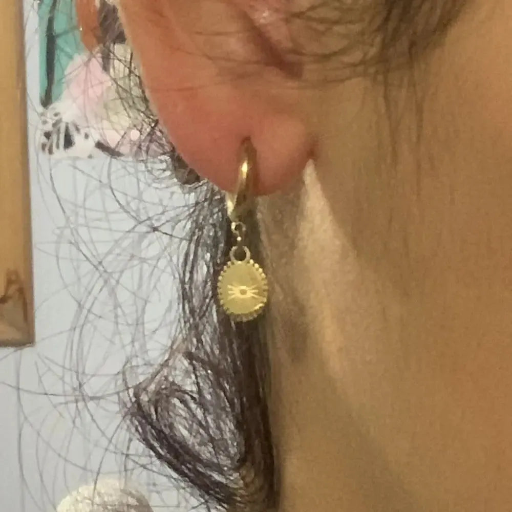 A pair of geometric stainless steel ear button earrings with an ellipse detail, shown in colour XY-EH005.