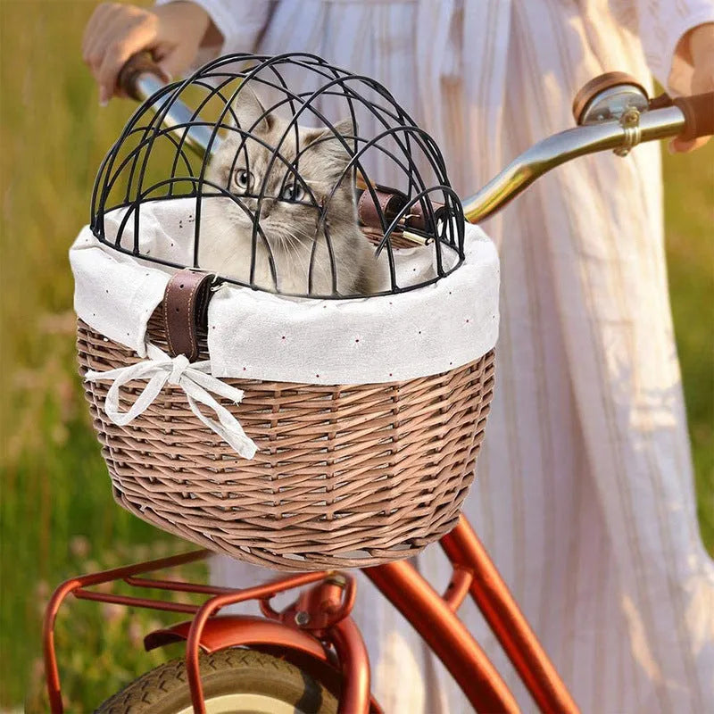 Medium honey-coloured wicker bicycle front basket for small cats and dogs on a road bike handlebar