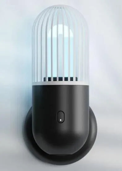 Portable capsule-shaped UVC disinfection lamp in black, showing compact size.