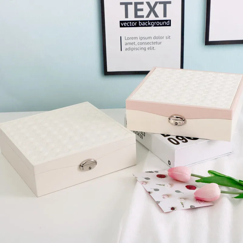Red or white PU leather jewelry storage box with multiple compartments for necklaces and rings.