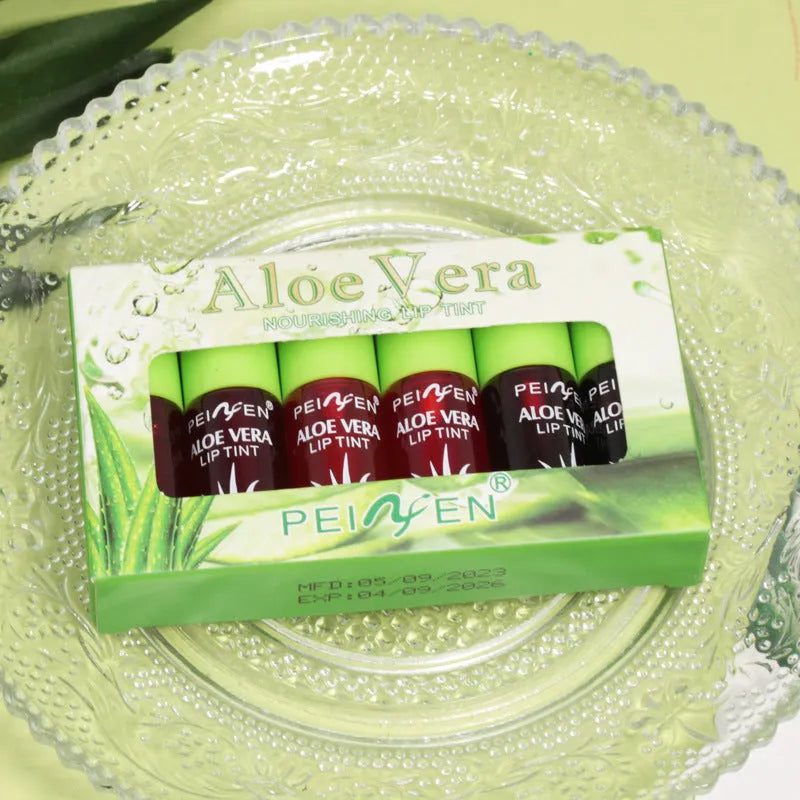 Set of six aloe lip gloss tubes in different colours on a light background