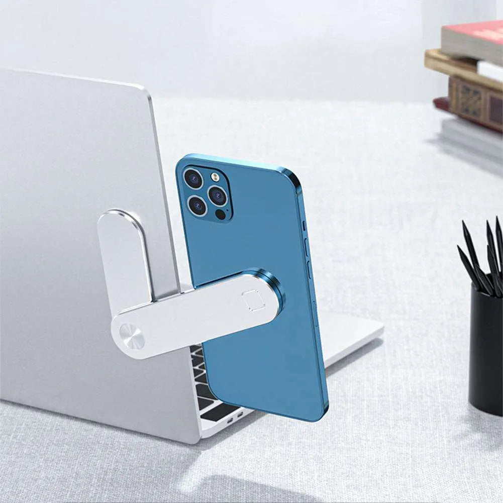 Black aluminium magnetic phone holder attached to side of silver laptop