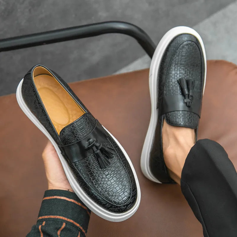Men's black casual fringed leather shoes with a low heel and round toe on a white background.