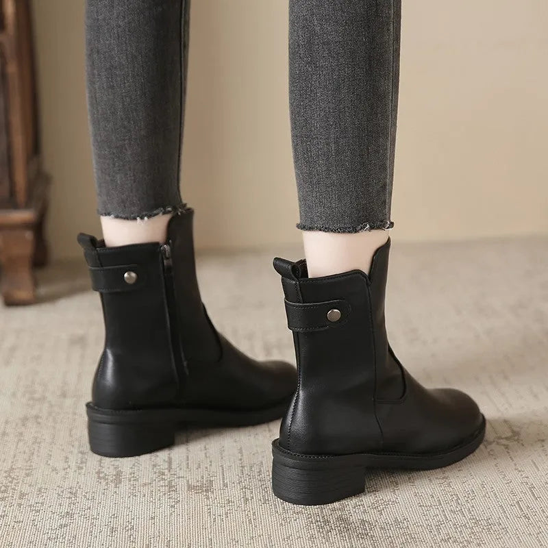 Black women's low heel boots with side zip and round toe on a white background.