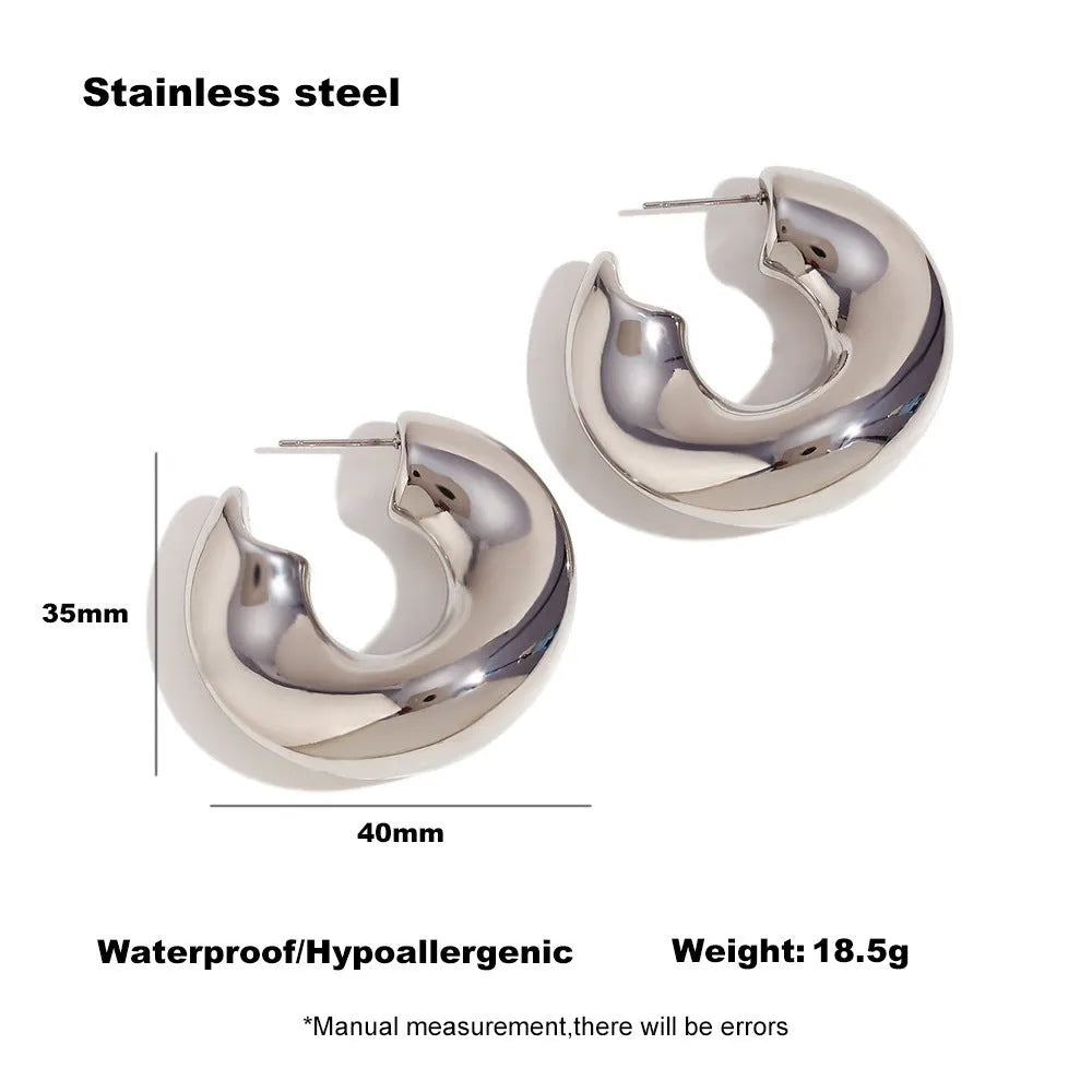 Gold and silver hollow irregular stainless steel earrings with geometric line design on white background