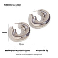 Gold and silver hollow irregular stainless steel earrings with geometric line design on white background