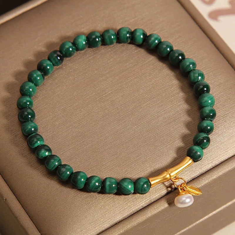 White crystal lucky bamboo bracelet with adjustable closure on a wrist.