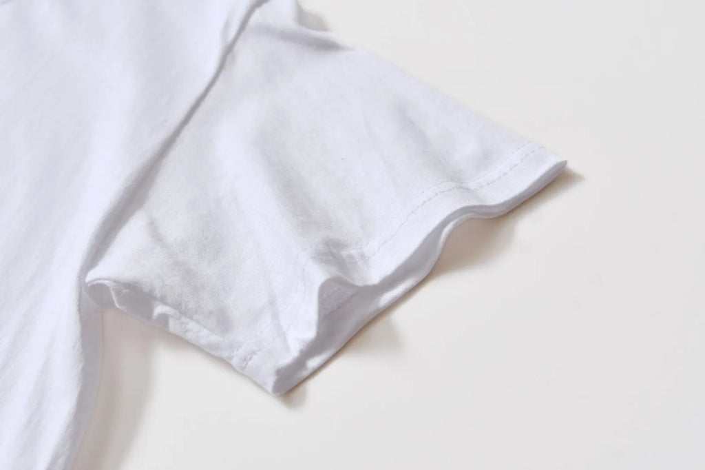 White cotton overalls with round neck and short sleeves in loose pullover style