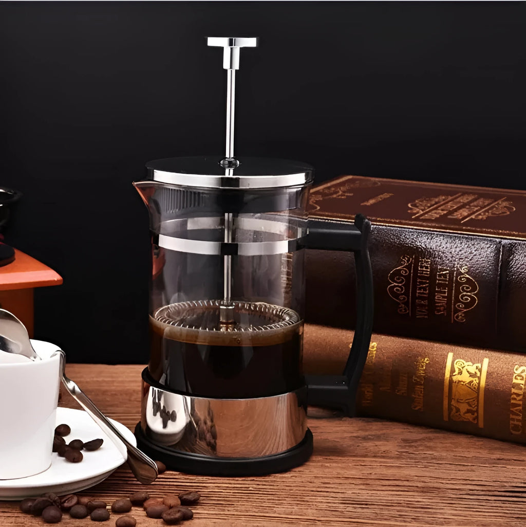 Compact pour-over coffee maker with glass carafe and stainless steel filter holder