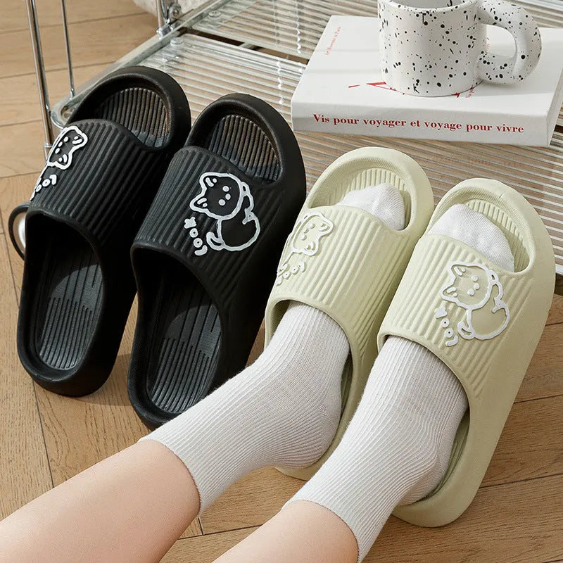 Women's green cat slippers with thick platform sole and flip-flop design on a white background.