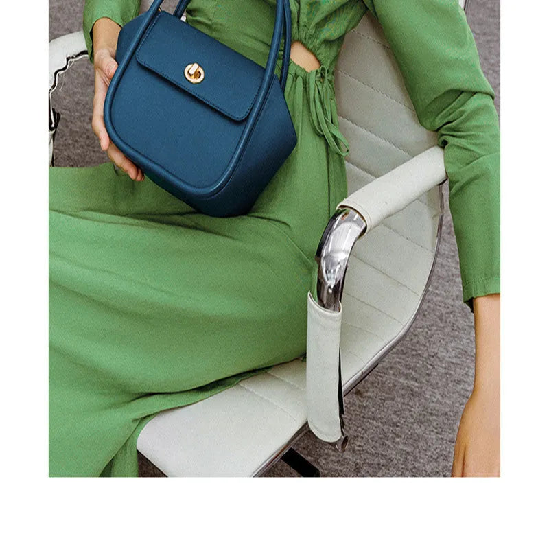 Genuine cow leather women's cross-body wing tote bag with latch closure and adjustable shoulder strap