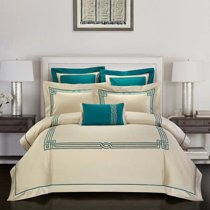 Four-piece cotton embroidery bedding set with detailed patterns on satin weave fabric