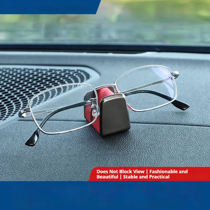 Zinc alloy and leather car dashboard clip for holding sunglasses, shown in green.