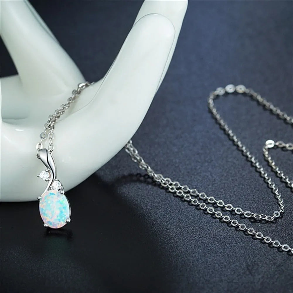 Water drop shaped opal pendant necklace on an adjustable chain in rose gold or white colour.