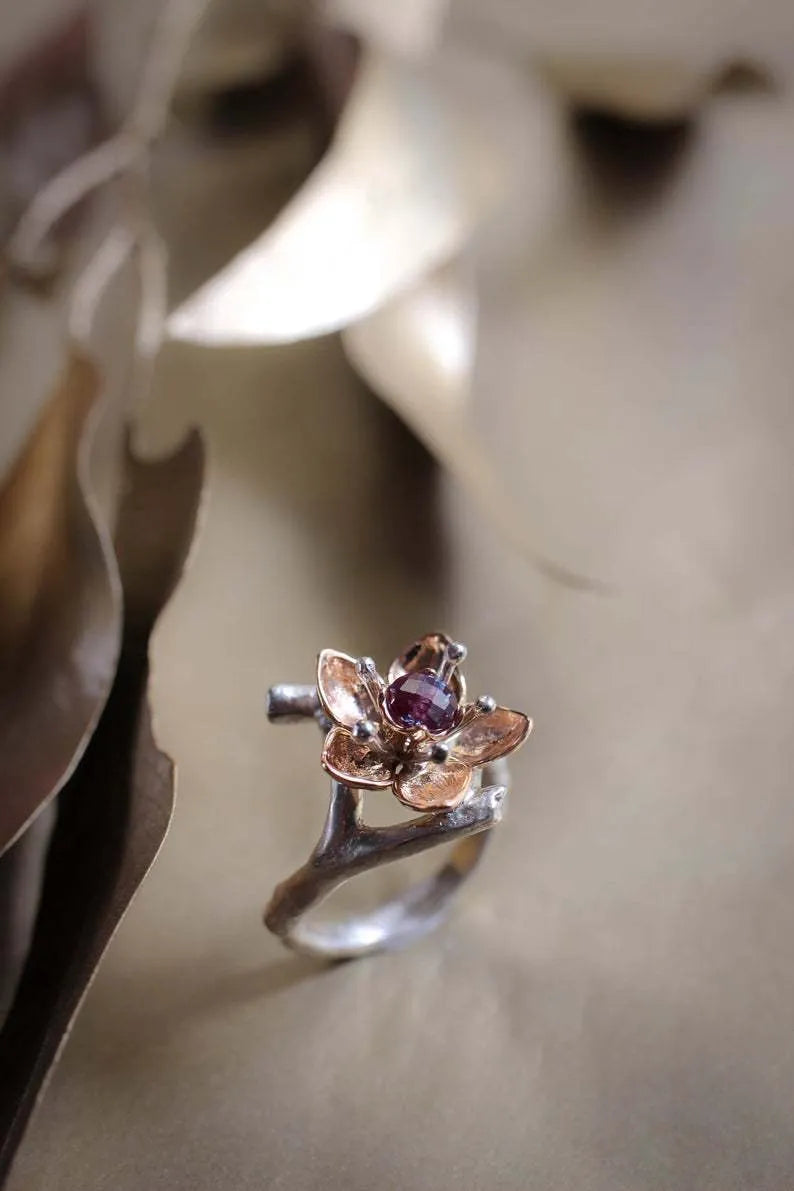 Silver two-tone floral geometric women's ring on display showing geometric shape and floral pattern detail.