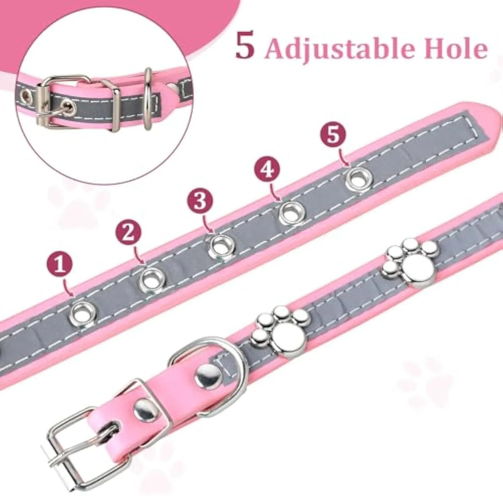 Reflective adjustable leather dog collar with cute paw rivet on a grey background.