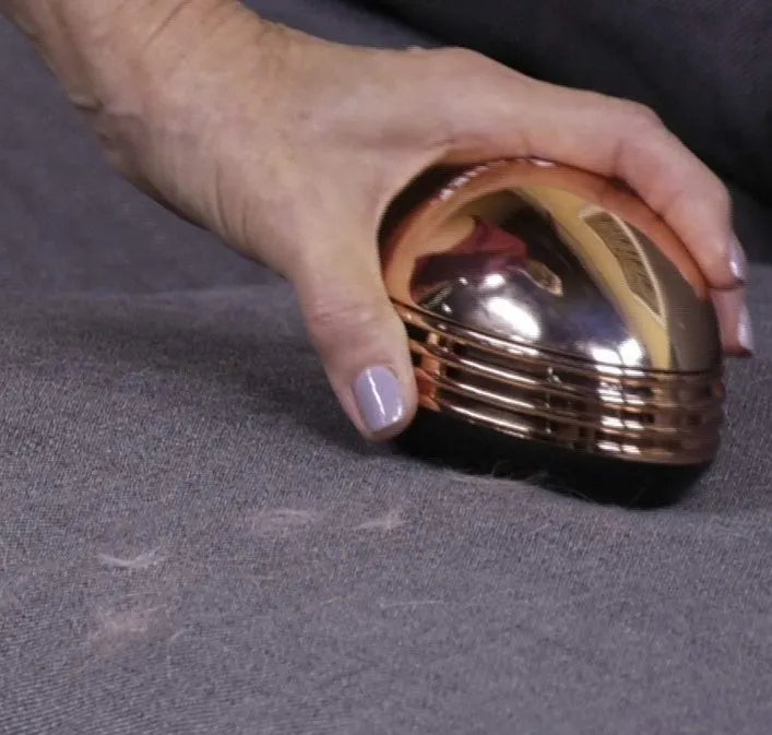 Gold portable mini desktop vacuum cleaner 18x12x10 cm on a wooden desk