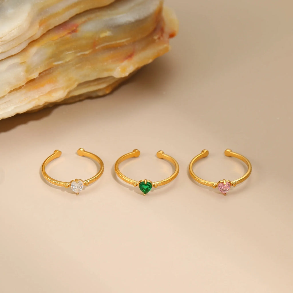 Open-ended stainless steel heart-shaped ring with inlaid zircon stones in green, pink, or white.