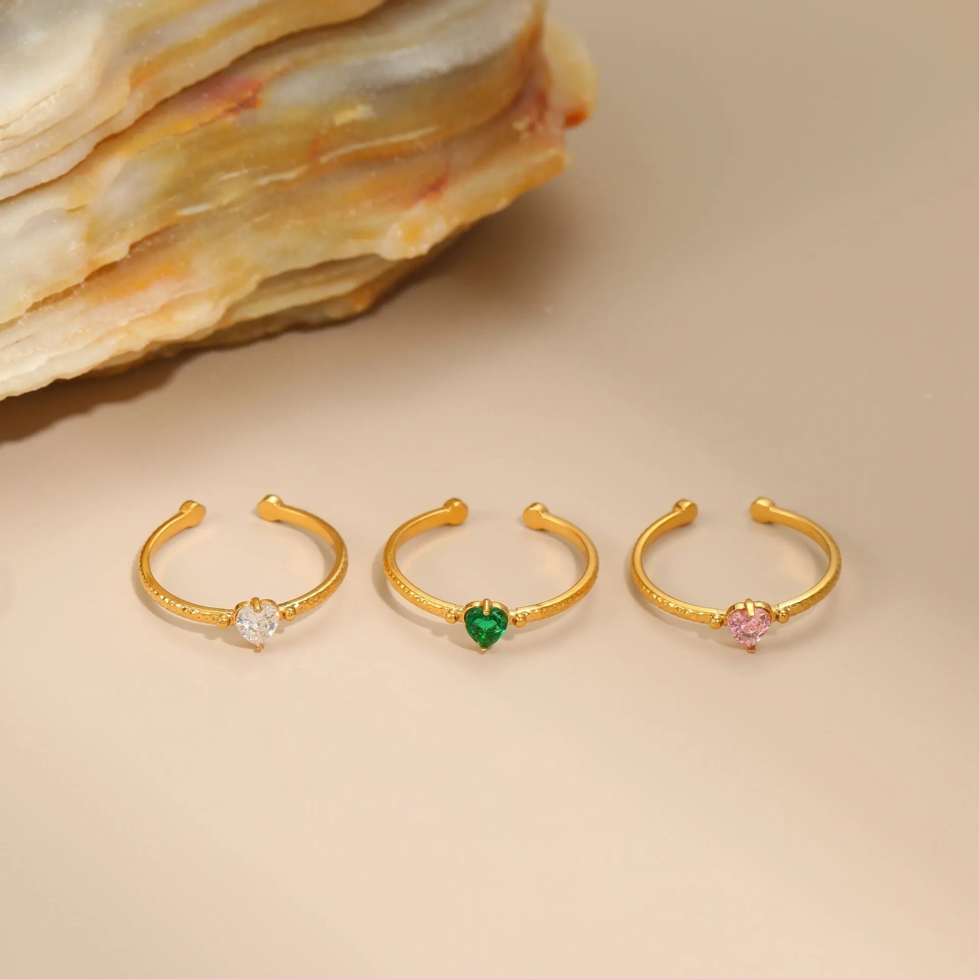 Open-ended stainless steel heart-shaped ring with inlaid zircon stones in green, pink, or white.