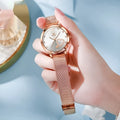 Women's fashion watch with rose gold mesh strap and choice of coloured dials on a wrist