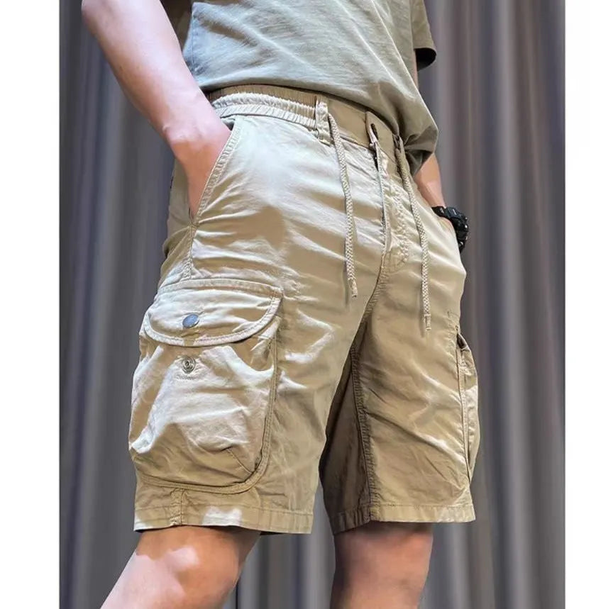 A pair of loose-fitting straight leg casual overalls in khaki colour with multiple pockets, shown laid flat.