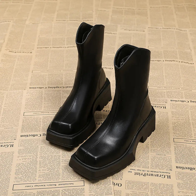 Black women's platform ankle boots with a square toe, chunky sole, and a back zip fastener.