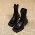 Black women's platform ankle boots with a square toe, chunky sole, and a back zip fastener.