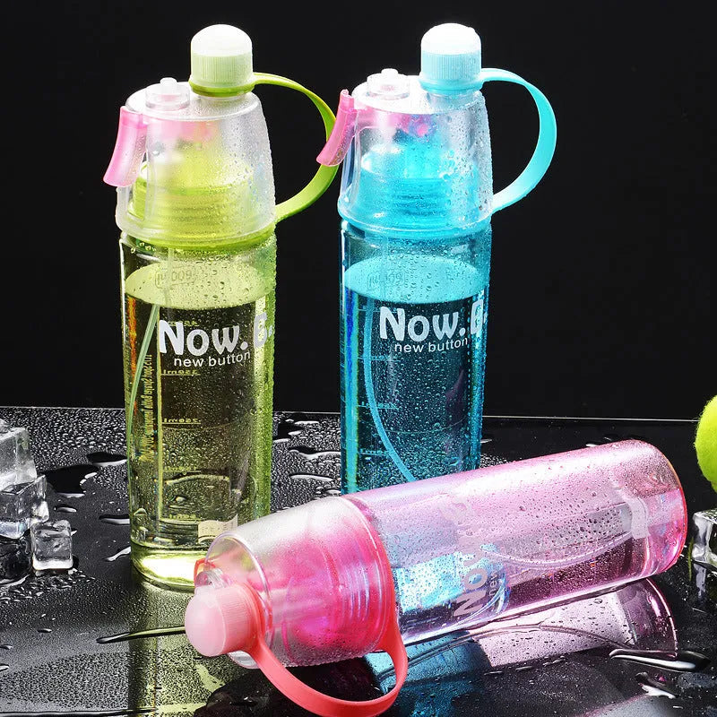 Portable mist spray sports water bottle with transparent body, handle, and press-to-spray mouth
