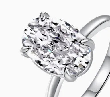 Oval cut solitaire ring in sterling silver with four-claw setting.