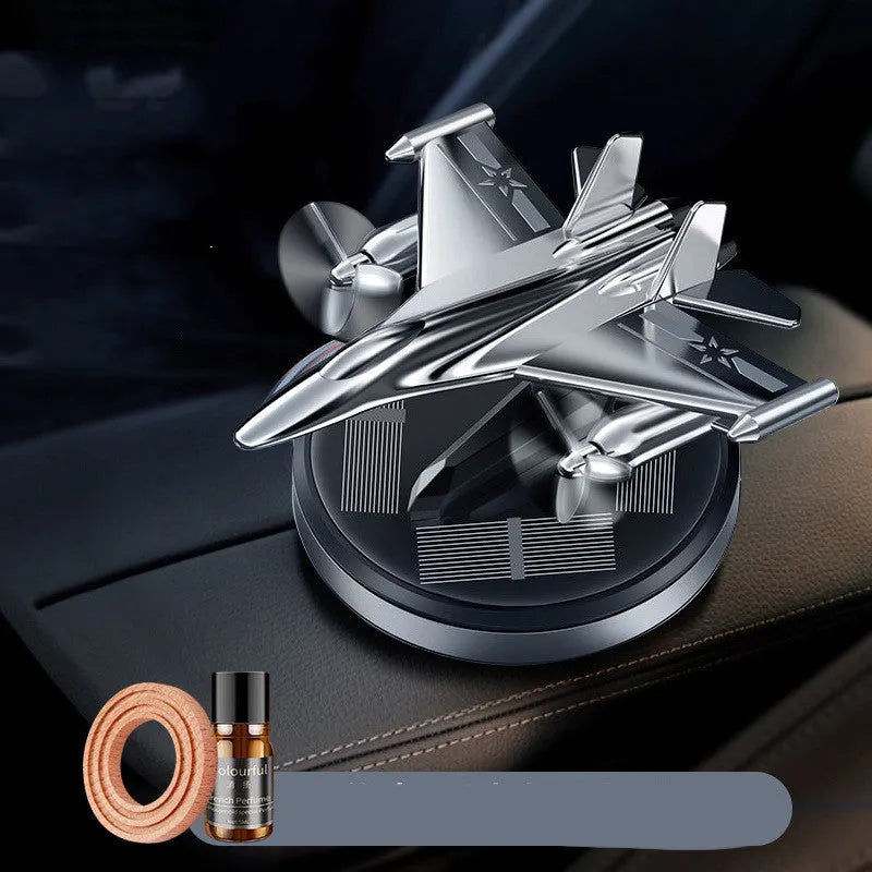 Silver solar-powered rotating fighter aircraft perfume ornament on a beech wood diffuser with essential oil bottle