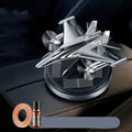 Silver solar-powered rotating fighter aircraft perfume ornament on a beech wood diffuser with essential oil bottle