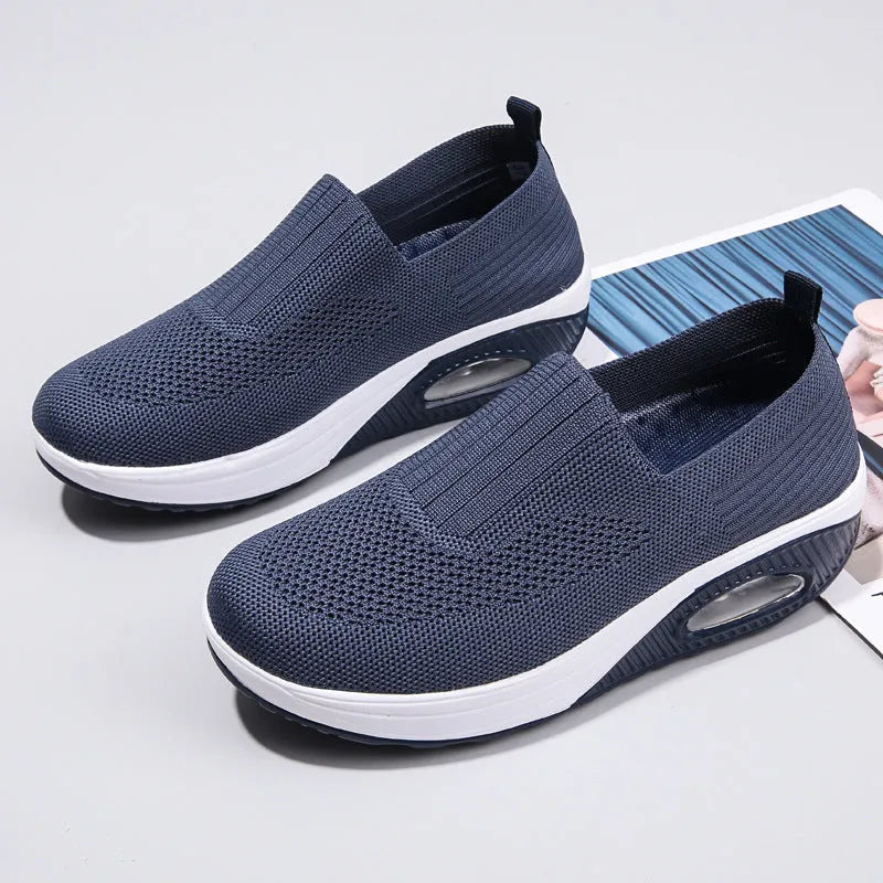 Women's mesh running shoes in beige with round toe and air cushion sole.