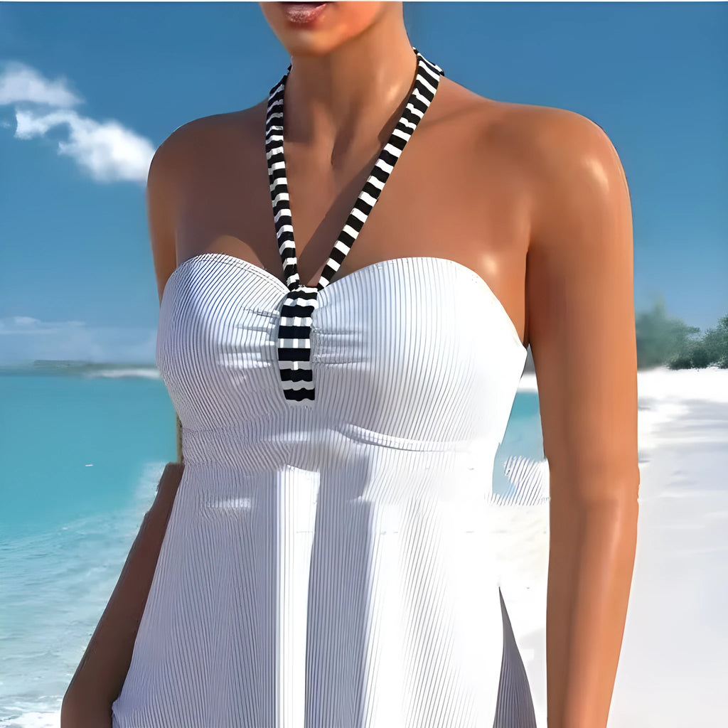 Women's off-shoulder swimsuit with solid colour top and black and white striped briefs