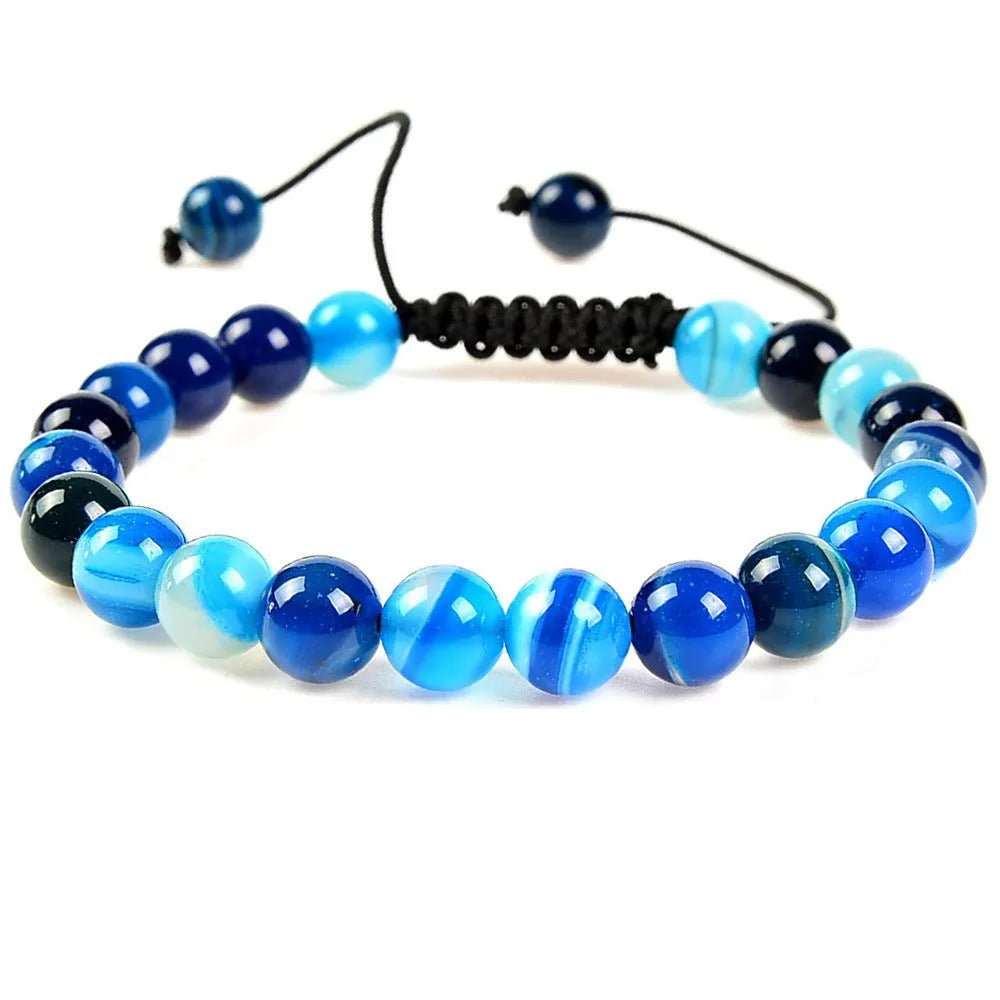 Natural 8mm polished crystal stretch bracelet with amethyst beads on a white background