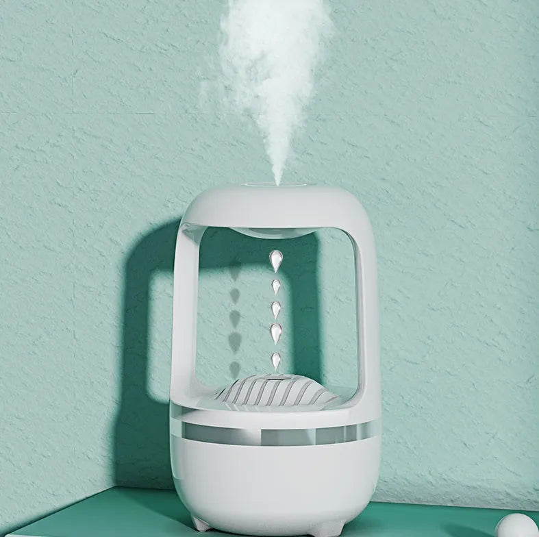 Anti-gravity humidifier with water droplet effect on desk next to USB cable