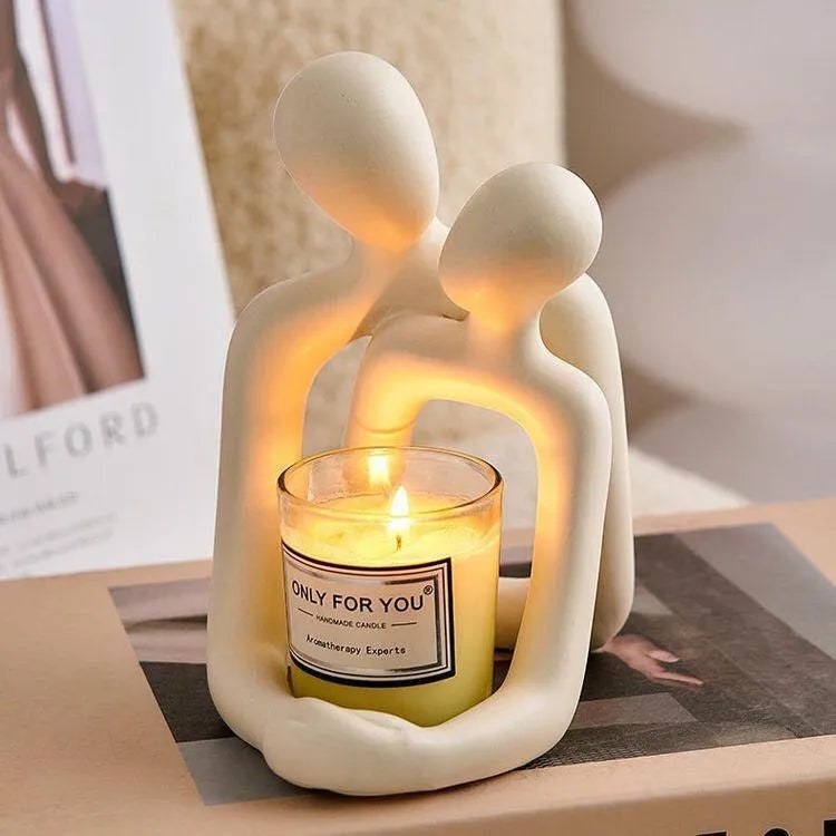 Modern minimalist resin statue of a loving couple in gold or milky white finish.