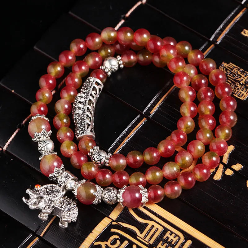 Watermelon crystal bracelet with Chinese knot design showing geometric natural stone beads